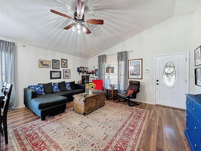 living room with vaulted ceiling, a textured ceiling, wood finished floors, and a ceiling fan
