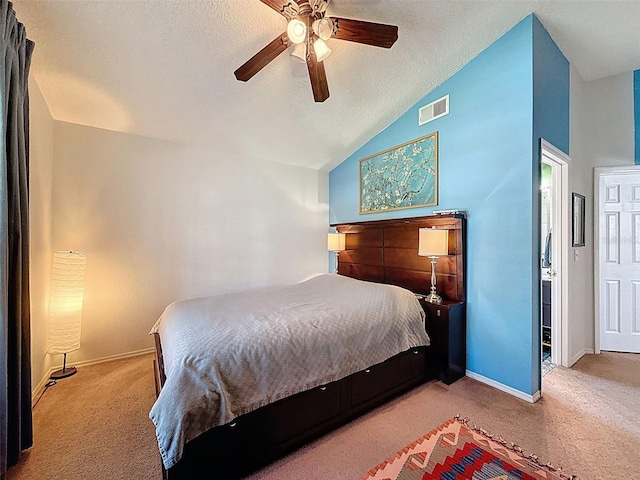 carpeted bedroom featuring a textured ceiling, lofted ceiling, and ceiling fan