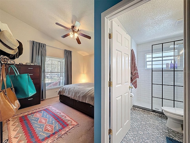 bedroom featuring a textured ceiling, lofted ceiling, and ceiling fan