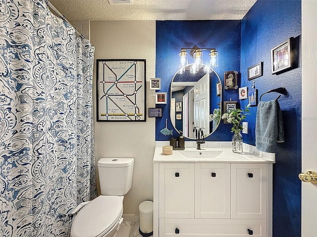 full bath with vanity and a textured wall