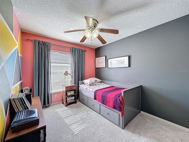 bedroom featuring a textured ceiling, carpet flooring, and ceiling fan