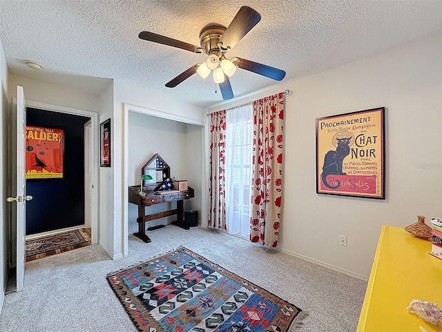 foyer featuring carpet flooring, a textured ceiling, and a ceiling fan