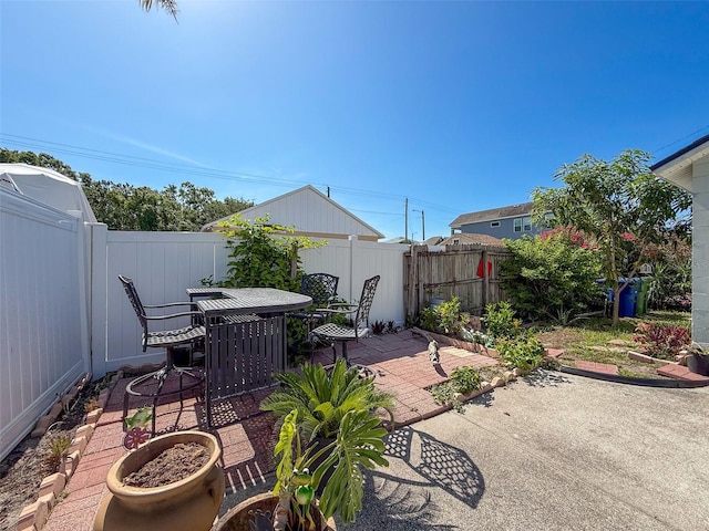 fenced backyard featuring a patio and outdoor dining area