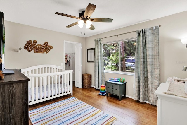 2454 Shadecrest Rd, Land O Lakes, FL 34639 - bedroom with hardwood / wood-style flooring, a nursery area, and ceiling fan