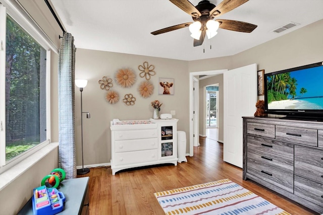 2454 Shadecrest Rd, Land O Lakes, FL 34639 - bedroom featuring multiple windows, light wood-type flooring, and a ceiling fan