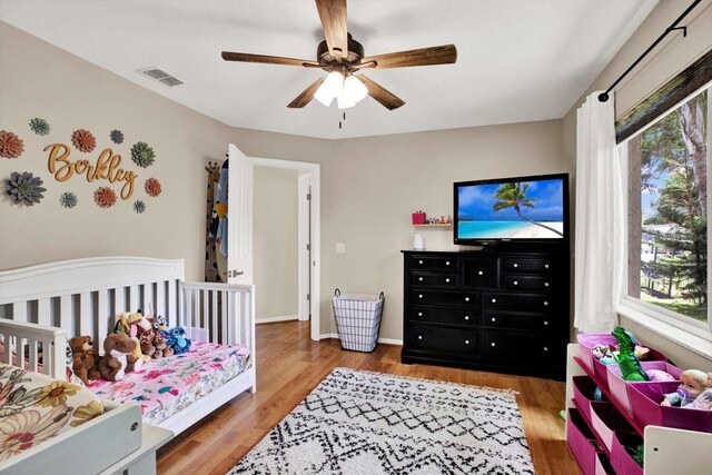 2454 Shadecrest Rd, Land O Lakes, FL 34639 - bedroom featuring wood finished floors and ceiling fan