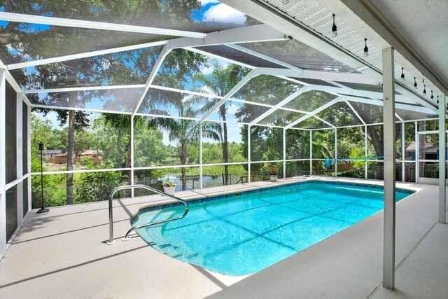 2454 Shadecrest Rd, Land O Lakes, FL 34639 - outdoor pool with a patio and glass enclosure