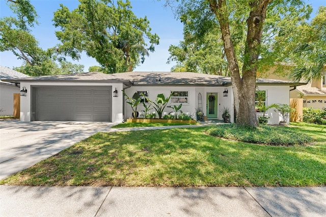 1313 W Carissa Ct, Tampa, FL 33604 - view of front of home featuring stucco siding, a front lawn, driveway, and an attached garage