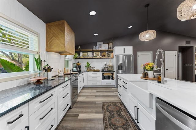 1313 W Carissa Ct, Tampa, FL 33604 - kitchen featuring appliances with stainless steel finishes, open shelves, vaulted ceiling, white cabinets, and decorative backsplash