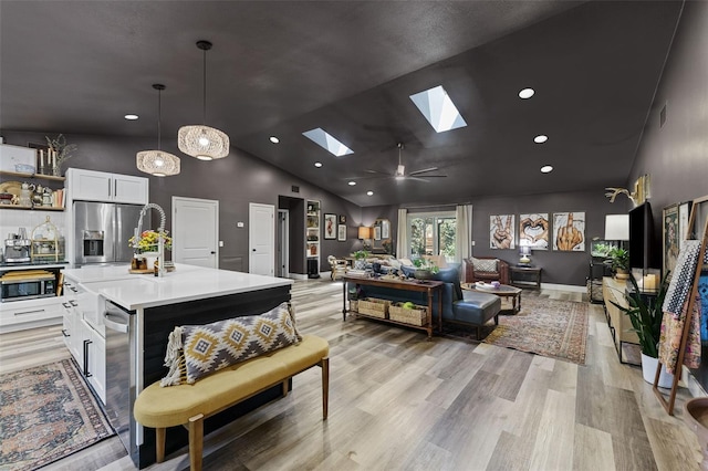 1313 W Carissa Ct, Tampa, FL 33604 - living area with a skylight, recessed lighting, light wood finished floors, and high vaulted ceiling