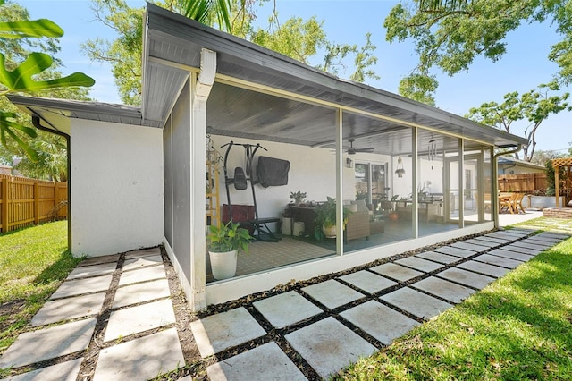 1313 W Carissa Ct, Tampa, FL 33604 - rear view of house with a sunroom, a patio, stucco siding, and ceiling fan