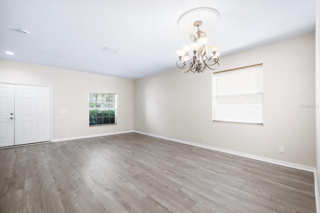 11132 Creek Haven Dr, Riverview, FL 33569 - empty room featuring a chandelier, wood finished floors, and a smoke detector
