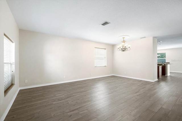 11132 Creek Haven Dr, Riverview, FL 33569 - spare room featuring a chandelier, healthy amount of natural light, and dark wood finished floors