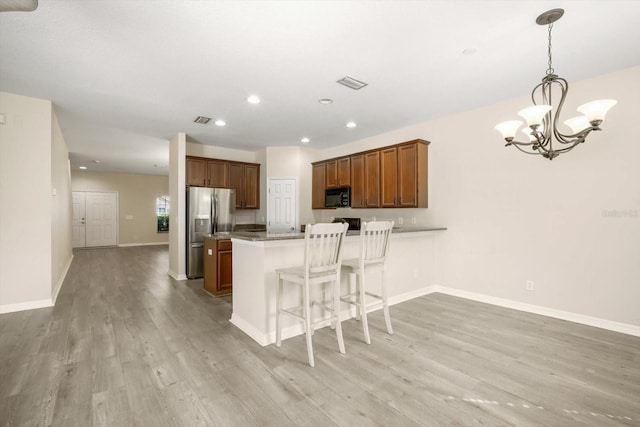 11132 Creek Haven Dr, Riverview, FL 33569 - kitchen with stainless steel refrigerator with ice dispenser, light wood-type flooring, a chandelier, a peninsula, and recessed lighting