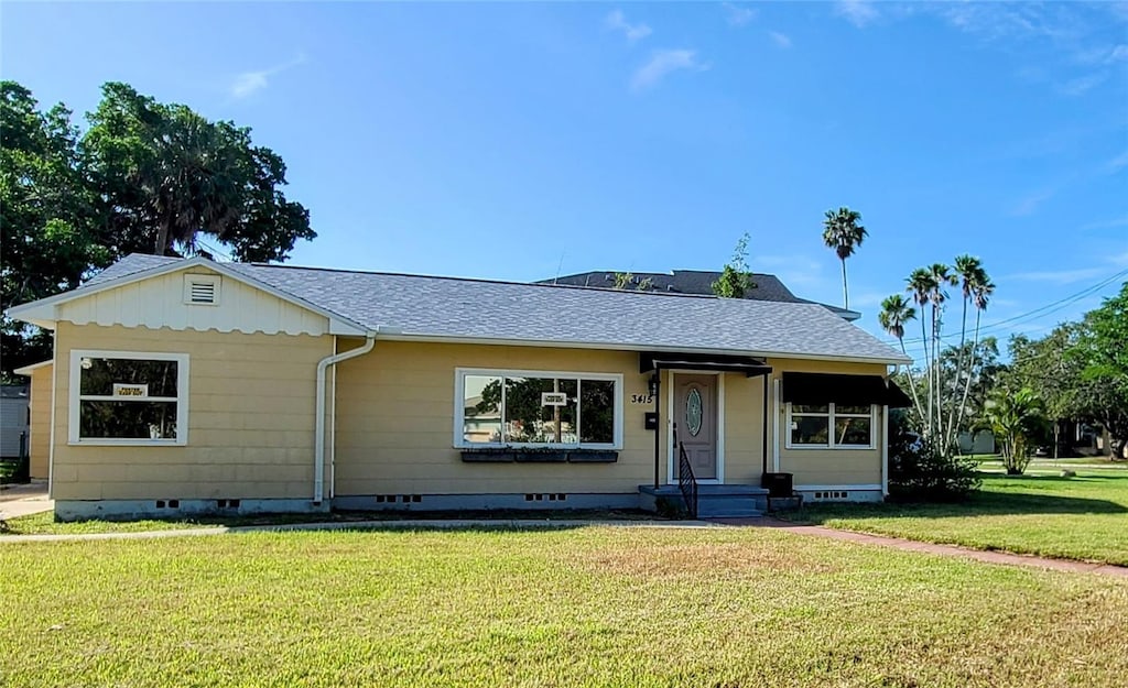 3415 Overlook Dr NE, Saint Petersburg, FL 33703 - bungalow featuring crawl space, a front lawn, and a shingled roof