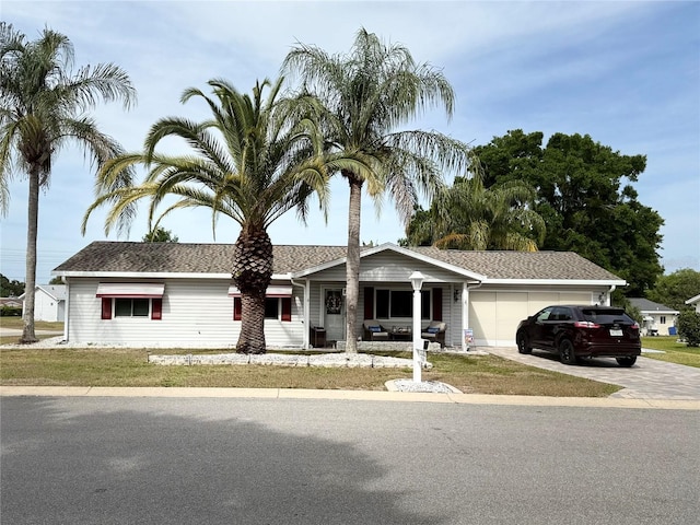 17569 SE 107th Ct, Summerfield, FL 34491 - single story home with driveway, an attached garage, and covered porch