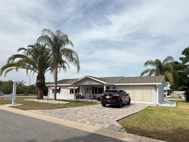 17569 SE 107th Ct, Summerfield, FL 34491 - ranch-style house featuring decorative driveway, a front lawn, a porch, and an attached garage