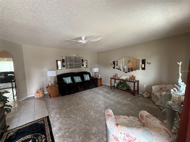 17569 SE 107th Ct, Summerfield, FL 34491 - living room with a ceiling fan, arched walkways, a textured ceiling, and carpet flooring