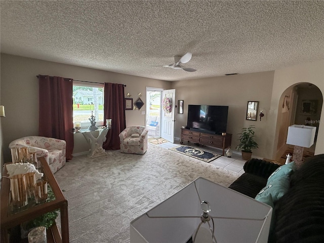 17569 SE 107th Ct, Summerfield, FL 34491 - tiled living area with arched walkways, a ceiling fan, and a textured ceiling