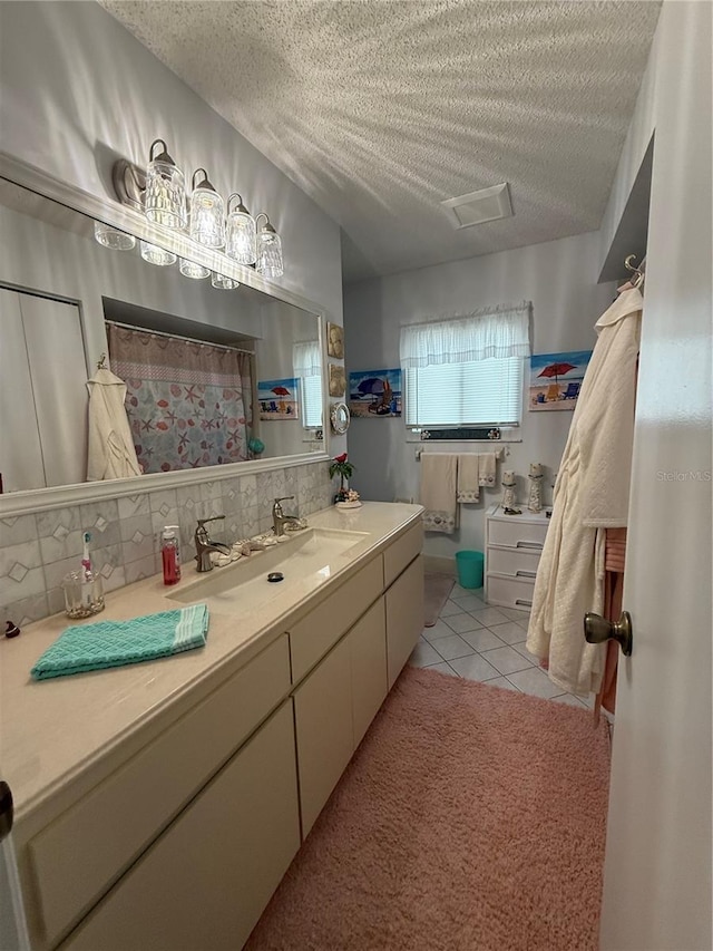 17569 SE 107th Ct, Summerfield, FL 34491 - bathroom with a textured ceiling, vanity, tile patterned floors, and tasteful backsplash