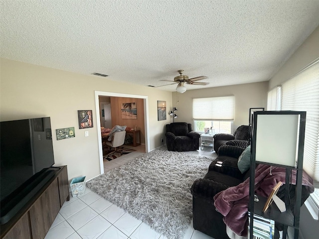 17569 SE 107th Ct, Summerfield, FL 34491 - tiled living room with a textured ceiling and ceiling fan