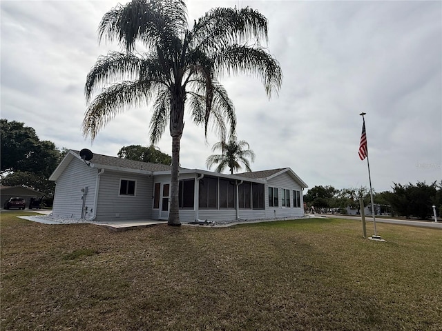 17569 SE 107th Ct, Summerfield, FL 34491 - back of house featuring a lawn and a sunroom