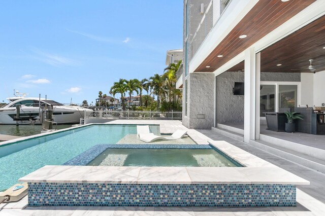 905 Bay Point Dr, Madeira Beach, FL 33708 - view of pool featuring a pool with connected hot tub and a patio