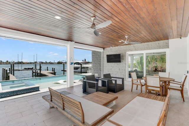905 Bay Point Dr, Madeira Beach, FL 33708 - view of patio with boat lift, a dock, a ceiling fan, outdoor dining area, and a water view