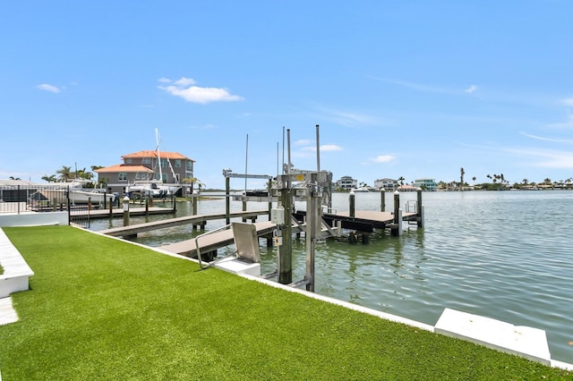 905 Bay Point Dr, Madeira Beach, FL 33708 - dock area with boat lift, a water view, and a lawn