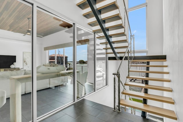 905 Bay Point Dr, Madeira Beach, FL 33708 - staircase with a ceiling fan and tile patterned floors