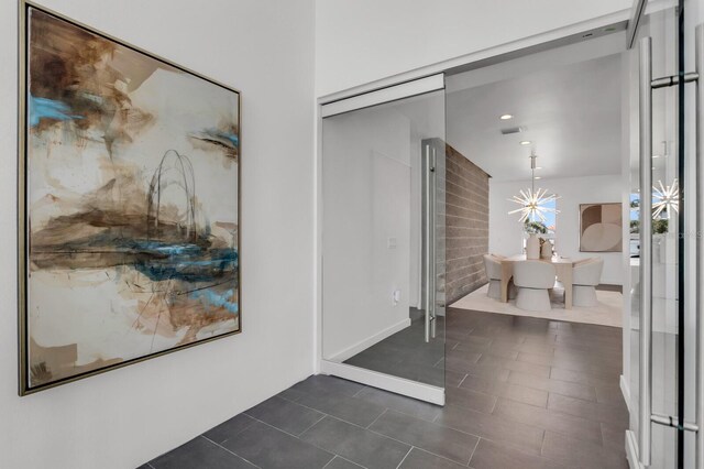 905 Bay Point Dr, Madeira Beach, FL 33708 - hall featuring dark tile patterned floors