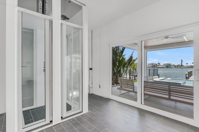 905 Bay Point Dr, Madeira Beach, FL 33708 - empty room featuring a water view and a ceiling fan