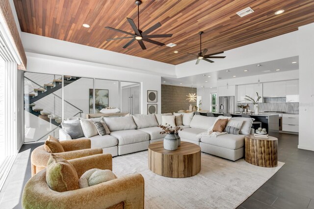 905 Bay Point Dr, Madeira Beach, FL 33708 - living room featuring ceiling fan, wooden ceiling, recessed lighting, and stairway