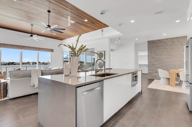 905 Bay Point Dr, Madeira Beach, FL 33708 - kitchen with dishwasher, open floor plan, ceiling fan, a center island with sink, and recessed lighting