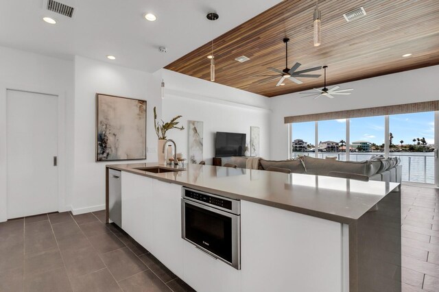 905 Bay Point Dr, Madeira Beach, FL 33708 - kitchen featuring wooden ceiling, open floor plan, a ceiling fan, an island with sink, and recessed lighting