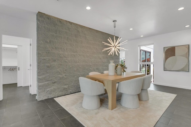 905 Bay Point Dr, Madeira Beach, FL 33708 - dining space with tile walls, recessed lighting, a chandelier, dark tile patterned floors, and an accent wall