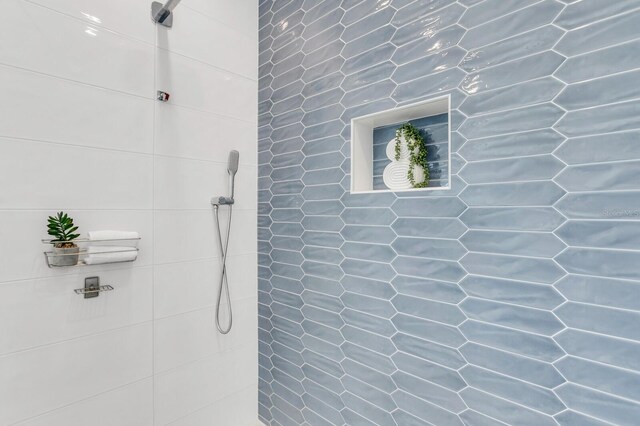 905 Bay Point Dr, Madeira Beach, FL 33708 - bathroom featuring a tile shower