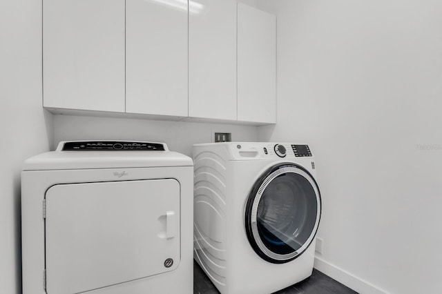 905 Bay Point Dr, Madeira Beach, FL 33708 - laundry area featuring cabinet space and washing machine and dryer