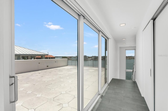 905 Bay Point Dr, Madeira Beach, FL 33708 - unfurnished sunroom featuring a water view