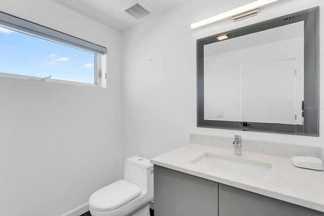 905 Bay Point Dr, Madeira Beach, FL 33708 - bathroom featuring vanity and toilet