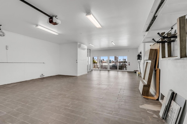 905 Bay Point Dr, Madeira Beach, FL 33708 - garage featuring a garage door opener and a wall unit AC