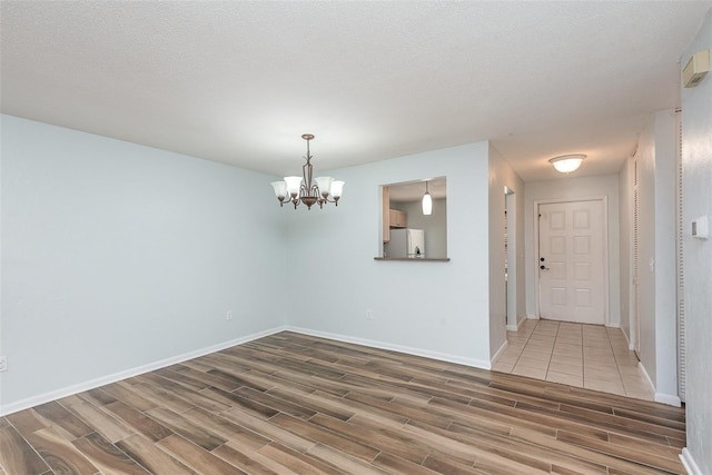 89 Fremont Ave Unit 504, Daytona Beach, FL 32114 - spare room featuring wood finished floors and a chandelier