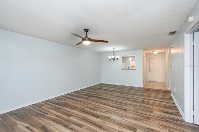 89 Fremont Ave Unit 504, Daytona Beach, FL 32114 - unfurnished room with wood finished floors, ceiling fan, a chandelier, a textured ceiling, and a smoke detector