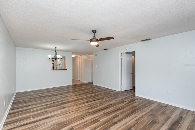 89 Fremont Ave Unit 504, Daytona Beach, FL 32114 - spare room with wood finished floors, a chandelier, ceiling fan, and a textured ceiling