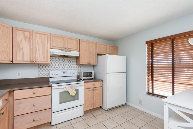 89 Fremont Ave Unit 504, Daytona Beach, FL 32114 - kitchen with white appliances, under cabinet range hood, light brown cabinetry, backsplash, and light tile patterned floors