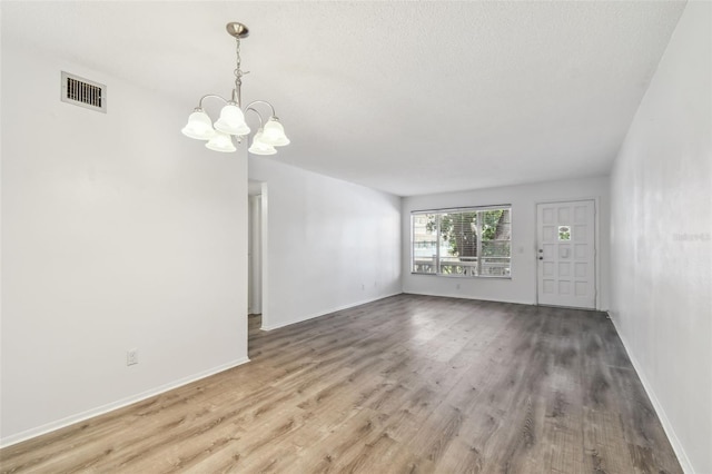 2310 Denmark St Unit 34, Clearwater, FL 33763 - unfurnished living room with a chandelier and wood finished floors