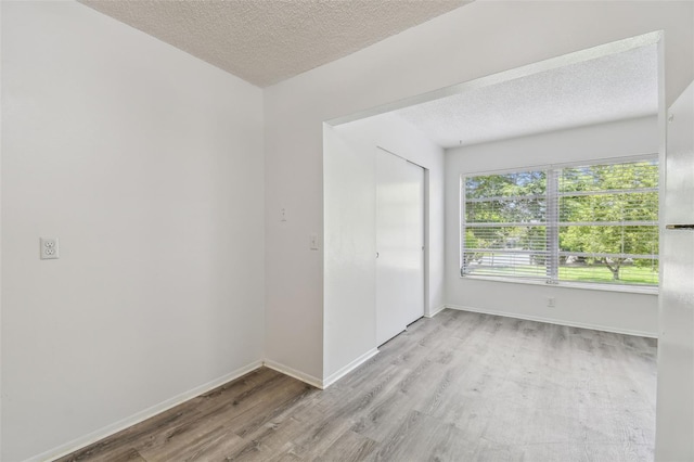 2310 Denmark St Unit 34, Clearwater, FL 33763 - unfurnished bedroom with wood finished floors, a textured ceiling, and a closet
