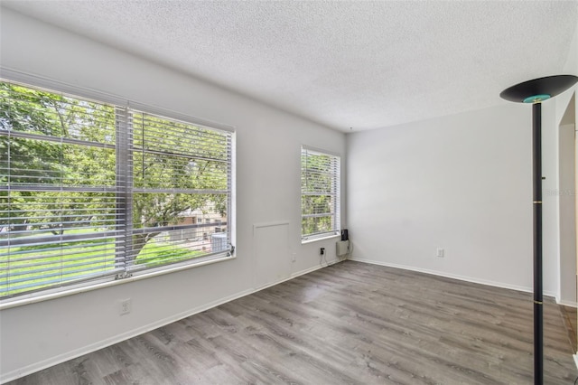 2310 Denmark St Unit 34, Clearwater, FL 33763 - unfurnished room with a textured ceiling and wood finished floors
