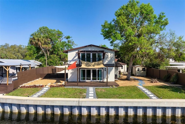6814 68th Ave E, Bradenton, FL 34203 - rear view of house with a shed, a fenced backyard, and stucco siding