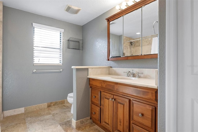 6814 68th Ave E, Bradenton, FL 34203 - bathroom featuring vanity, a textured wall, and a shower